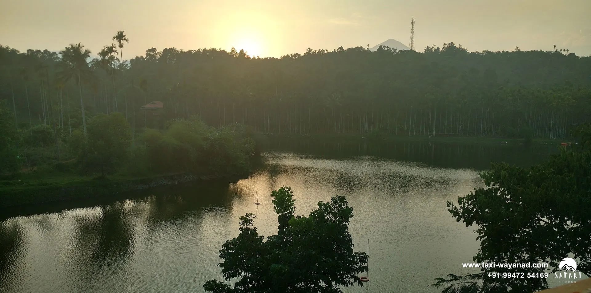 Sunset over Karlad Lake with forested hills behind, Wayanad