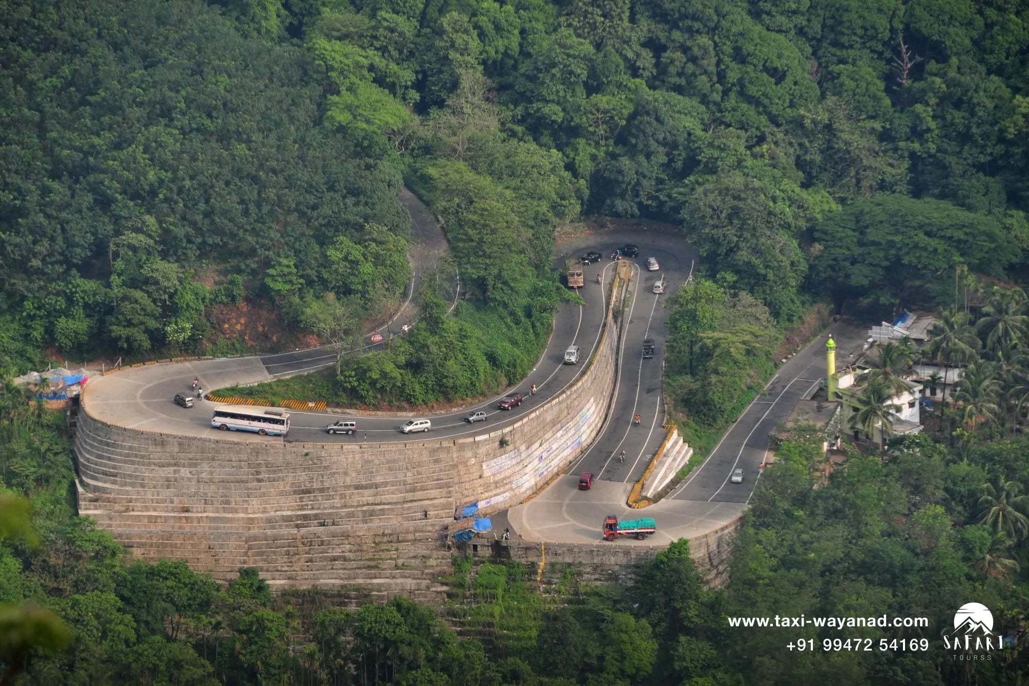Taxi, bus and truck traffic on a Wayanad ghat road hairpin bend