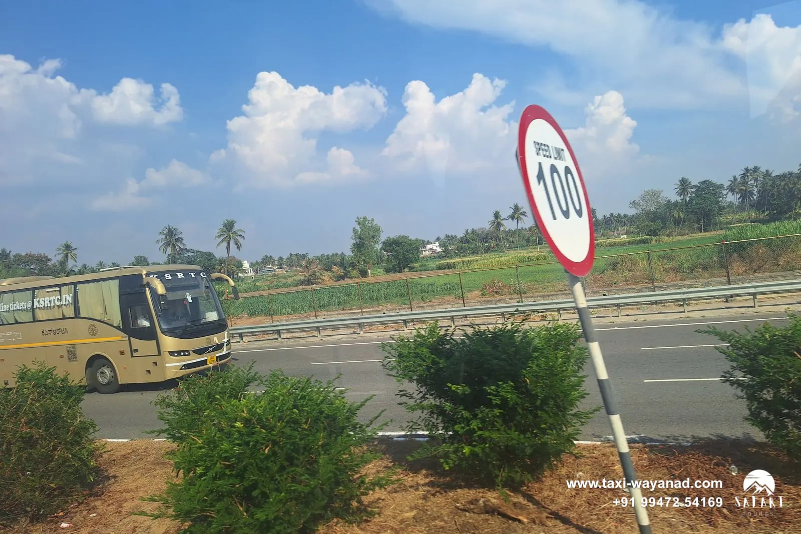 Bus on the Bengaluru–Mysuru Expressway beside a 100 km/h speed-limit sign