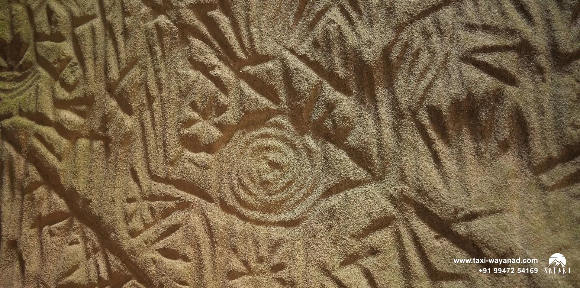 Prehistoric petroglyphs with spiral and human figures carved into the rock at Edakkal Caves, Wayanad