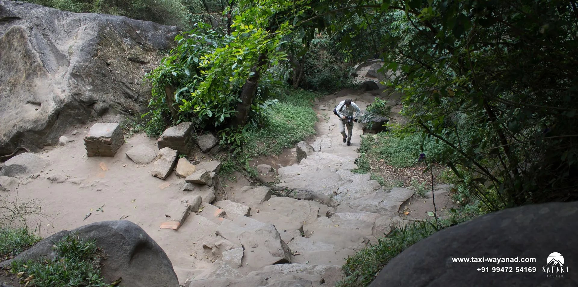 Rocky stone path climbing through greenery to Edakkal Caves, Wayanad
