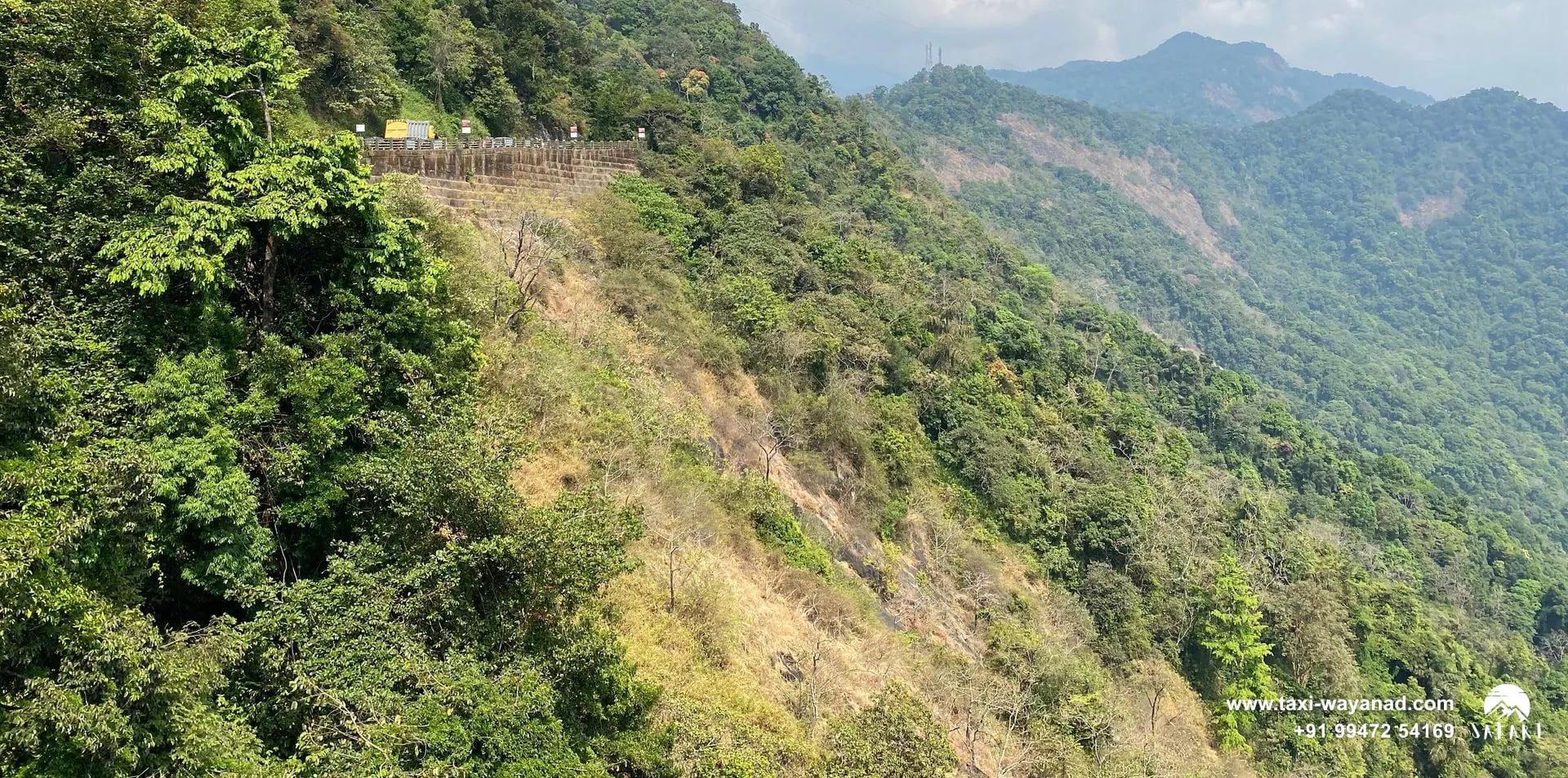 Forested hills under a cloudy sky at Lakkidi View Point, Wayanad