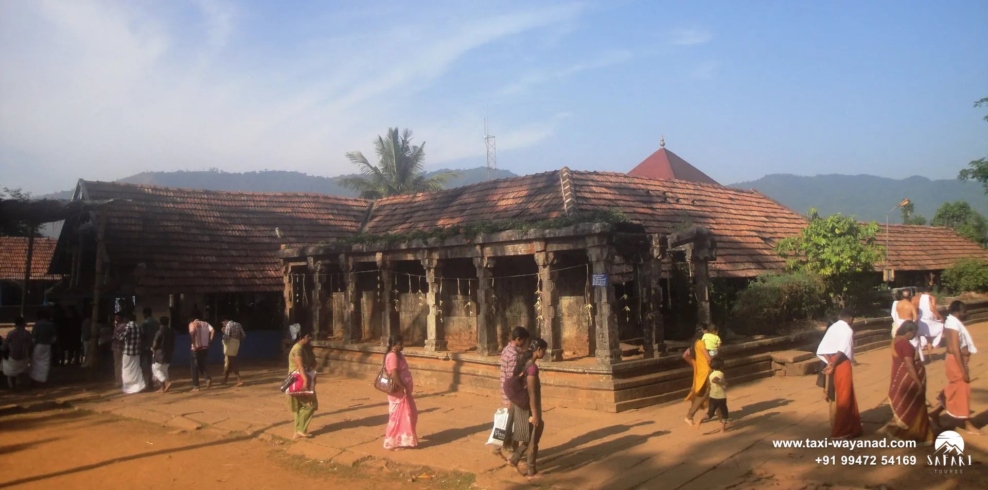 Devotees walking towards the tiled-roof front of Thirunelli Temple, Wayanad
