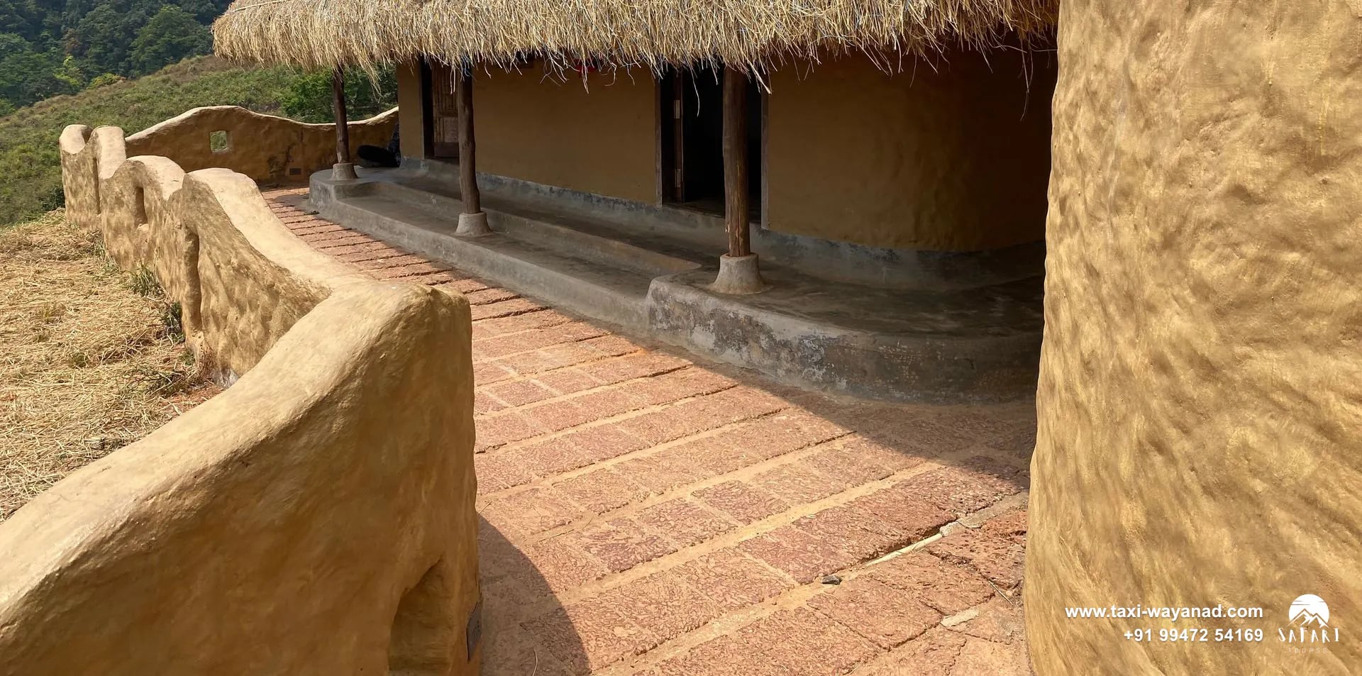 Traditional mud hut with a thatched dome roof at En Ooru tribal village, Wayanad